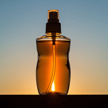 带有温暖日落逆光效果的琥珀色玻璃身体喷雾瓶模型