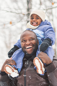 father and child boy in winter forest with parents and kids love relationship having warm clothes for cold climate