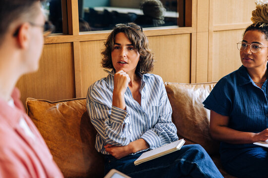 Young professionals engaged in discussion during a casual meeting