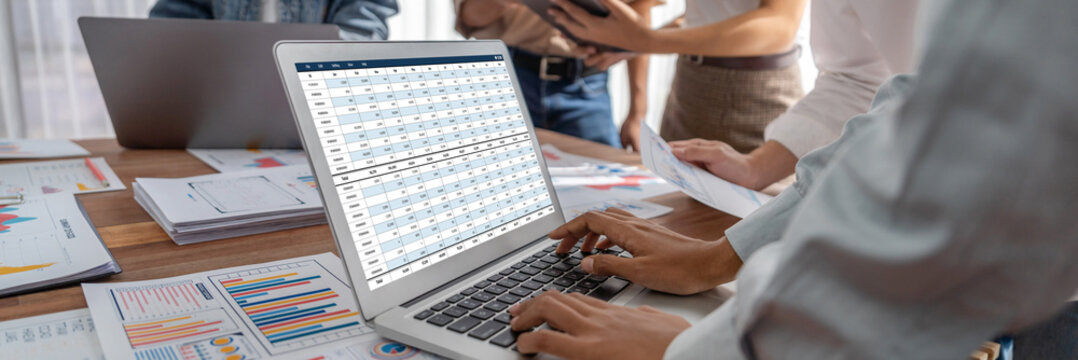 电脑屏幕上的会计软件显示企业财务报表电子表格和账户余额，助力会计人员实现精准高效的核算